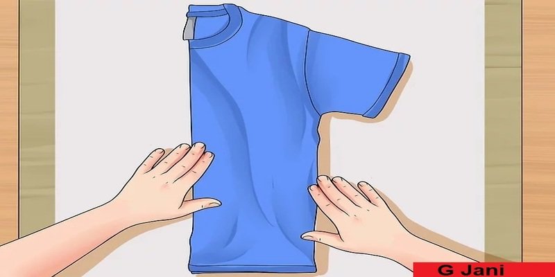 Fold the shirt in half.